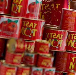A stack of Tasty Tom tins full of tomato paste, 推荐买球平台 also manufactures pasta, biscuits, yoghurt drinks and edible oils for 非洲n markets.